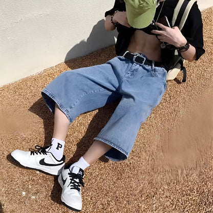 Men's blue washed denim shorts with high waist and cropped straight-leg design on a neutral background