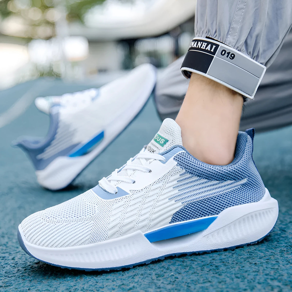 Men's blue mesh casual shoes with round toe and plastic sole on a white background.