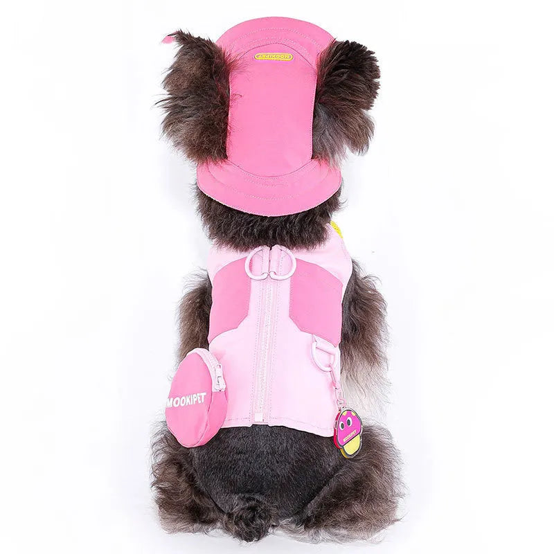 Pink polyester dog vest harness on a small white dog, showing back traction loop and casual fit.