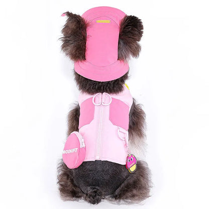 Pink polyester dog vest harness on a small white dog, showing back traction loop and casual fit.