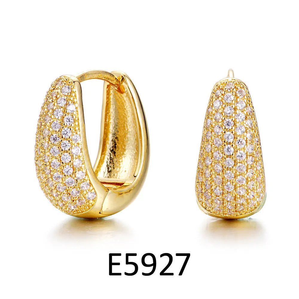 Gold plated heart-shaped clip-on earrings with multiple sparkling zircon stones on a white background.