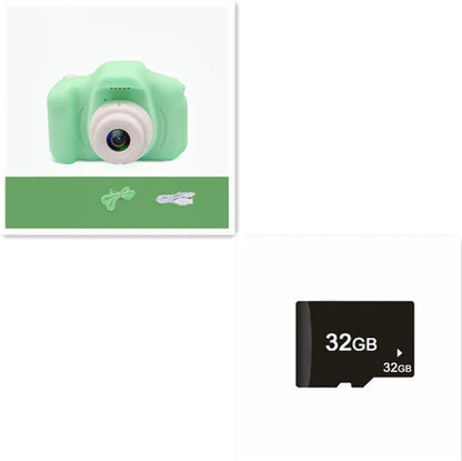 X2 HD mini digital camera for kids in silicone case with lanyard, shown capturing photo on 2-inch screen.
