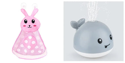 Grey or white electric whale bath toy spraying water with LED lights on a base.