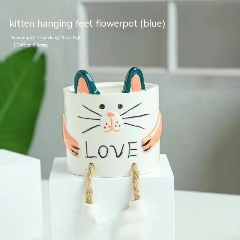 Ceramic hanging foot flowerpot with cartoon design for succulents on desktop