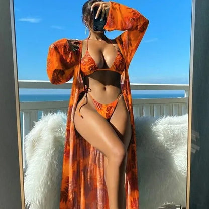 Polyester banded bikini set with long sleeve blouse, briefs, and robe cover-up in floral pattern