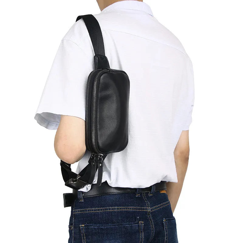 Men's small leather crossbody bag in black showing compact dimensions and crossbody strap