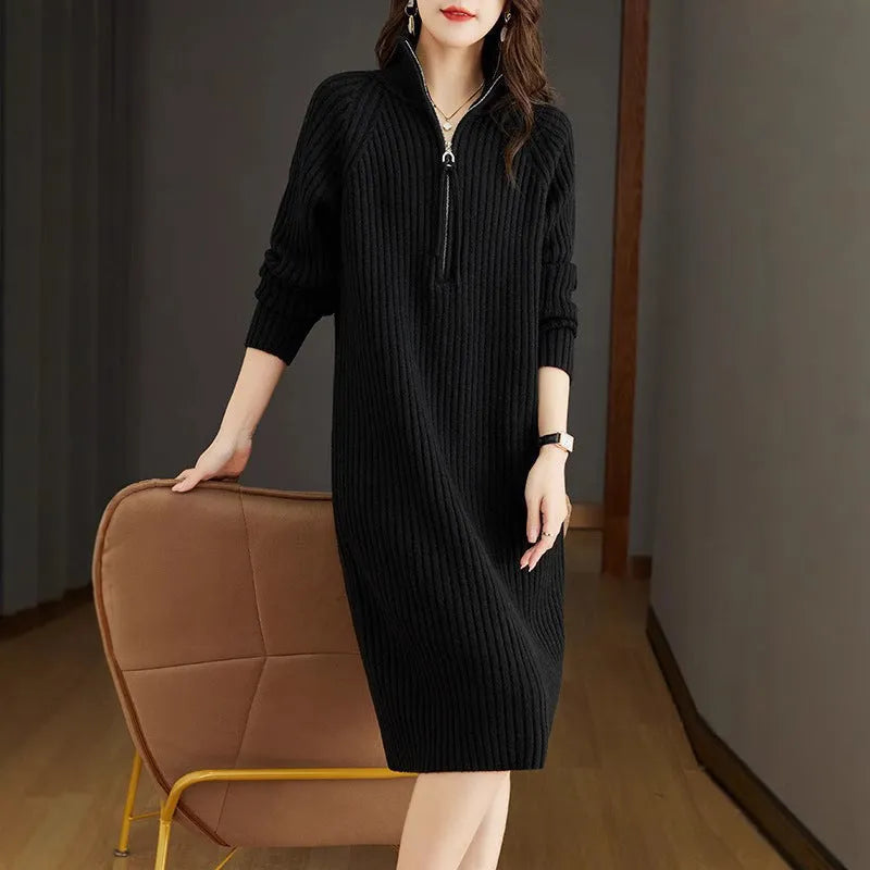 Beige half-zip woolen skirt with long sleeves, a stand collar, and a loose, straight midi silhouette.