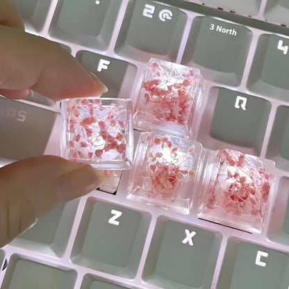 Transparent resin mechanical keyboard keycap with glitter starry sky effect in red, pink, green, or violet.