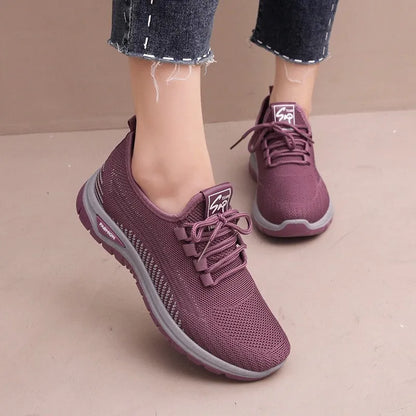 Women's black breathable mesh sneakers with round toe and cross strap lace-up detail