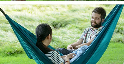 Premium double hammock made with soft, breathable fabric and reinforced ropes for outdoor use
