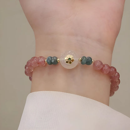 Women's bracelet with strawberry quartz stones and blue water emerald round jade pendant featuring peace buckle closure