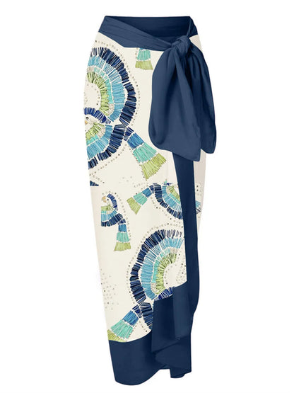 White women's one-shoulder swimsuit with draped lotus leaf design and high-leg split on a model