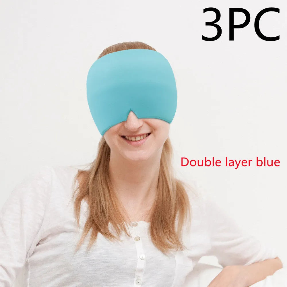 Black elastic cloth gel cold compress eye mask for headache relief on a grey background.