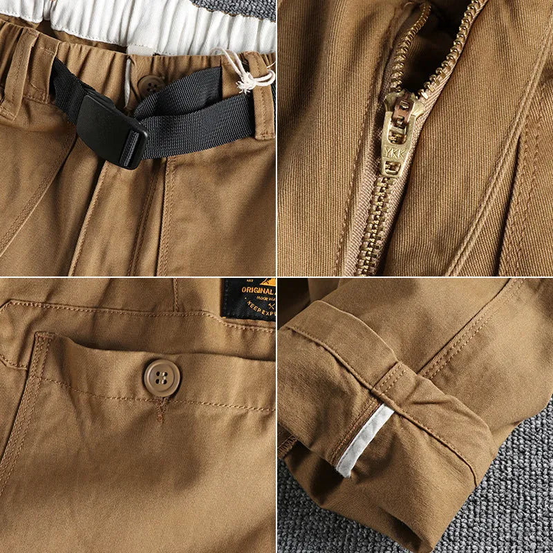 Men's khaki work trousers with a three-dimensional cut and an N I buckle belt on a hanger.