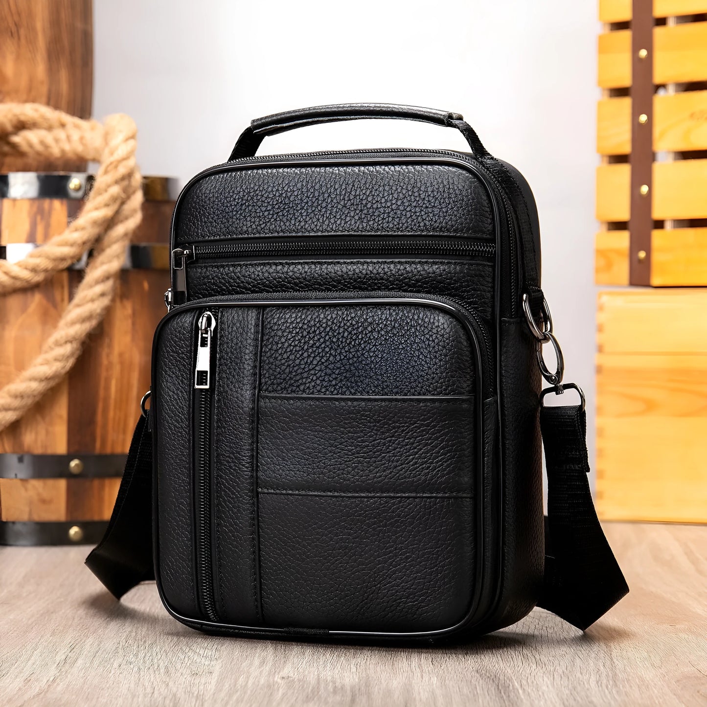Vertical vintage brown leather shoulder bag for men showing front zipper and soft handle.