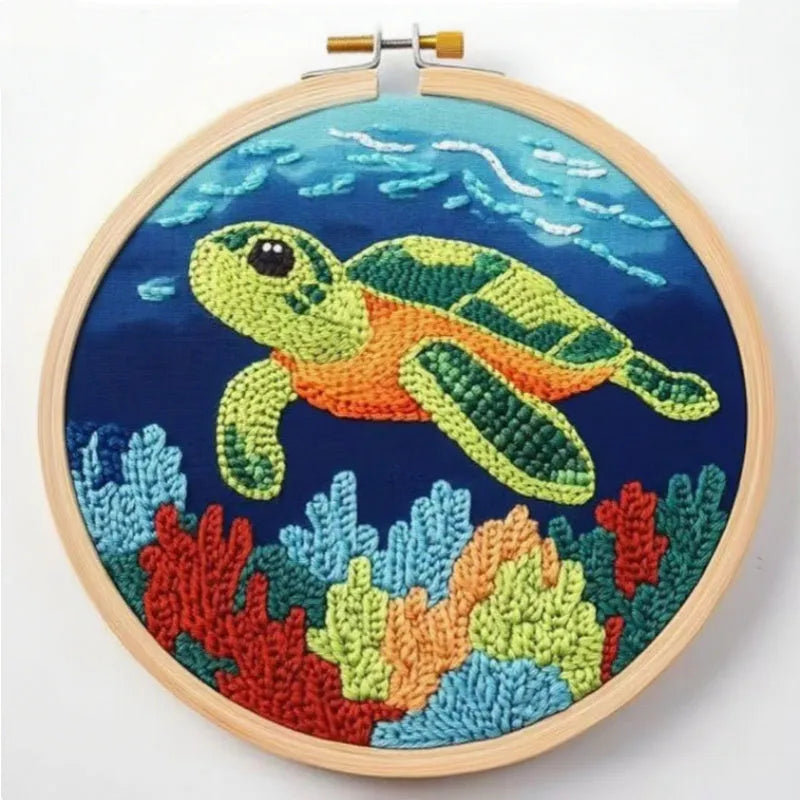 Beginner embroidery craft suit showing six cartoon designs including turtle, sheep, horse, fox, butterfly, and mermaid patterns