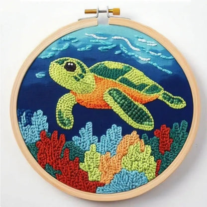 Beginner embroidery craft suit showing six cartoon designs including turtle, sheep, horse, fox, butterfly, and mermaid patterns