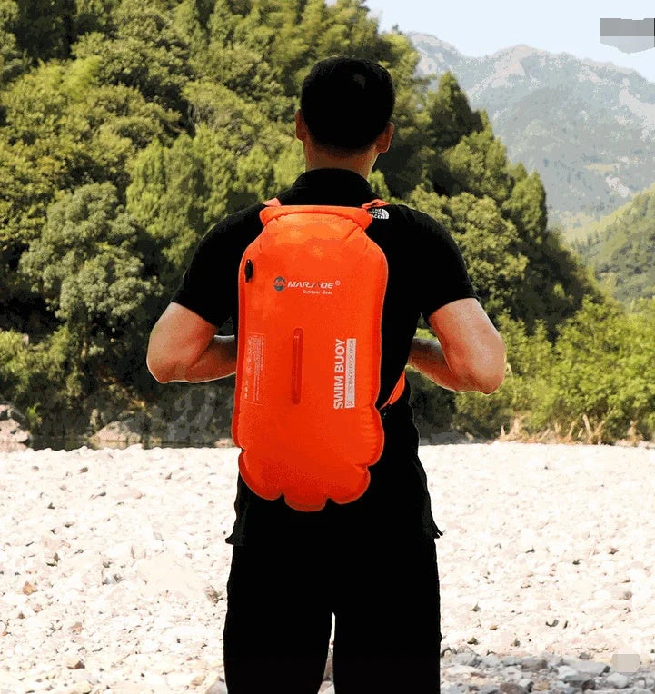 Double airbag swimming buoy backpack in fluorescent orange, showcasing its dual airbags and waterproof storage compartment.