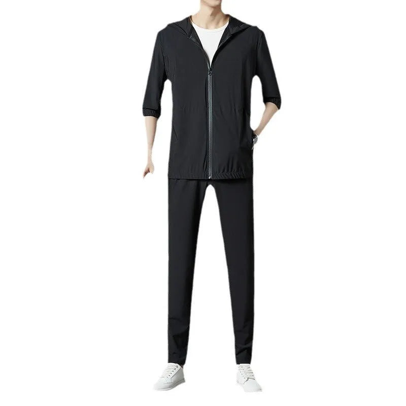 Grey hooded sun-protective top and loose pants suit for men on a hanger.