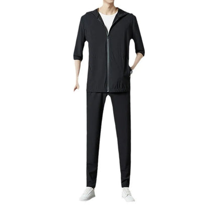 Grey hooded sun-protective top and loose pants suit for men on a hanger.