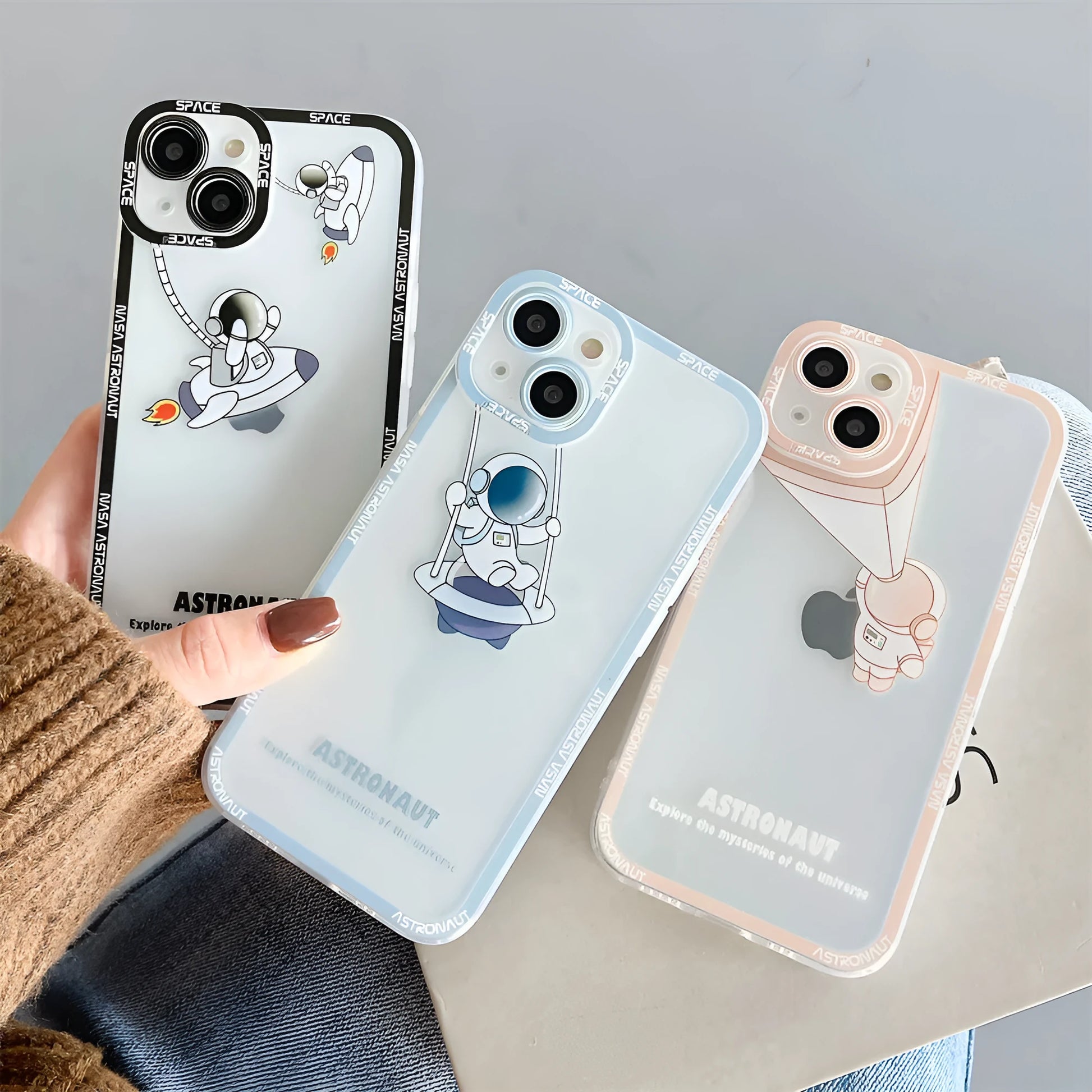 Transparent silicone iPhone case with blue astronaut print, showing compatibility with iPhone models.