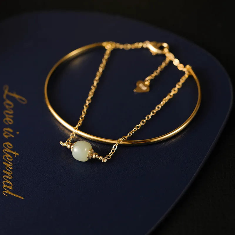 Women's Hetian jade lucky beads bracelet with gold inlay, shown in faux two-piece design.