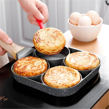Four-hole aluminium frying pan with medical stone non-stick coating and bakelite handle on a hob