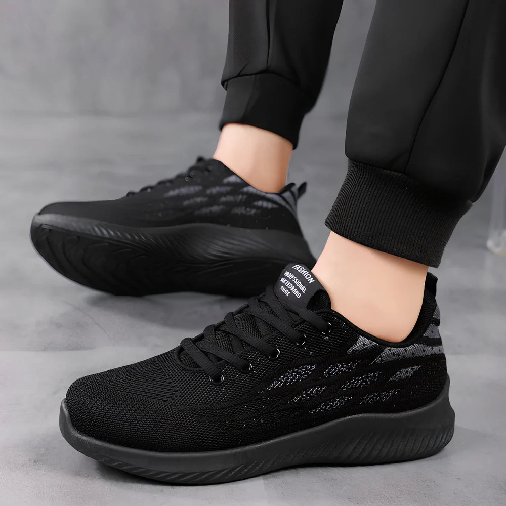 Men's black mesh sports shoes with red accent details and flexible PVC sole construction