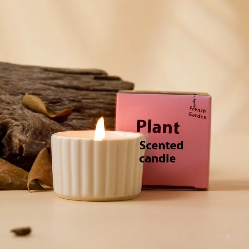 Soy wax aromatherapy candle inside a handmade ceramic cup, shown in a mint green colour.