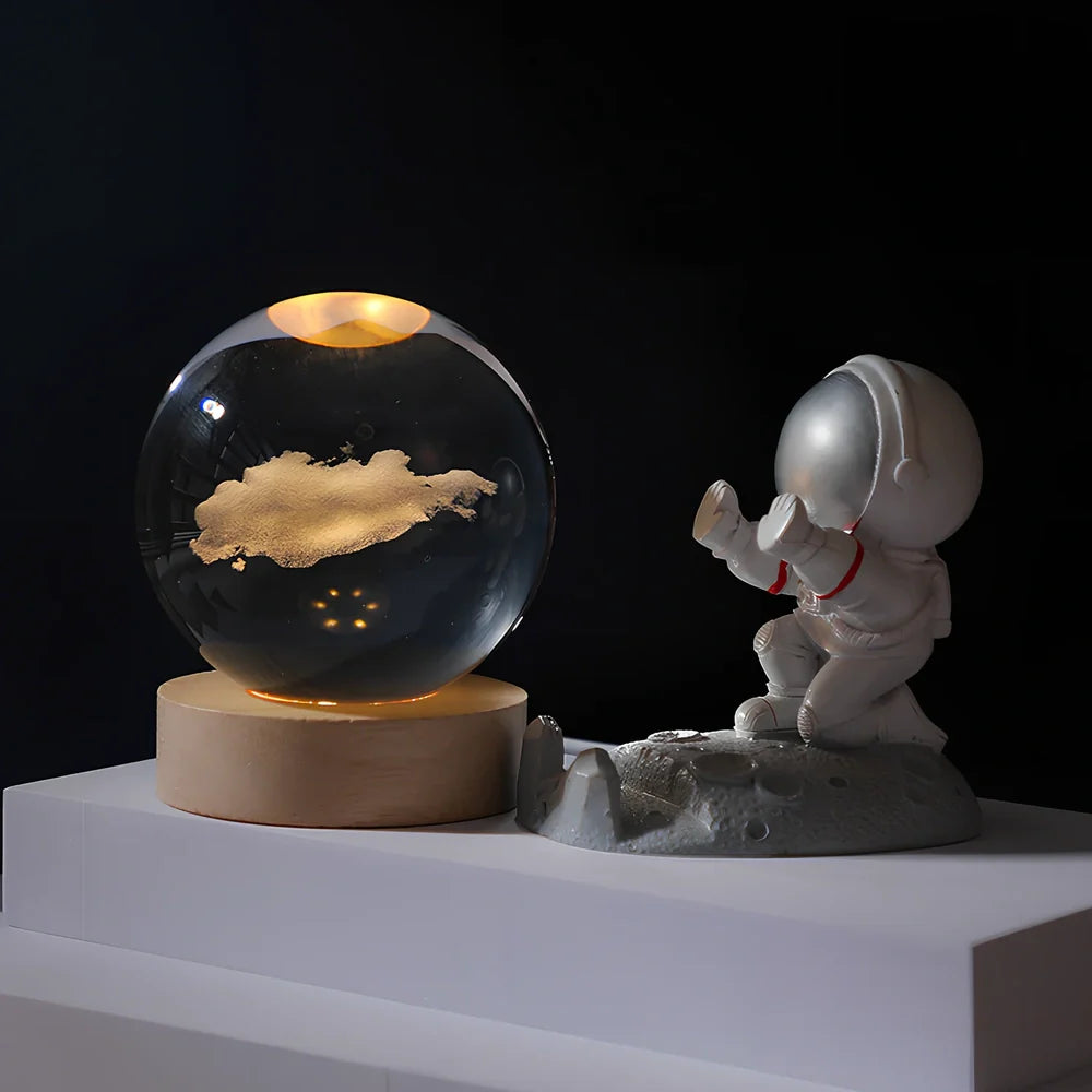 Cosmos Series crystal ball night light with wooden base and astronaut figure, showing Milky Way light pattern