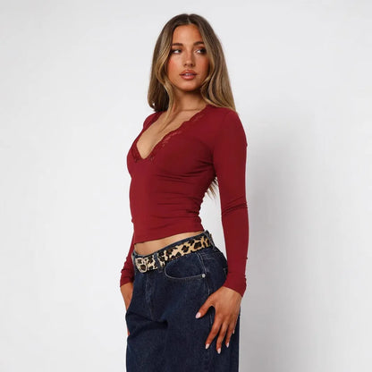 Women's slim fit black pullover top with long sleeves and decorative lace floral design.