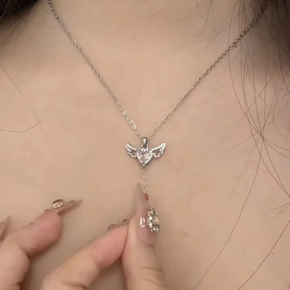 Elegant angel wings necklace with moving heart pendant, made of titanium steel and crystal accents