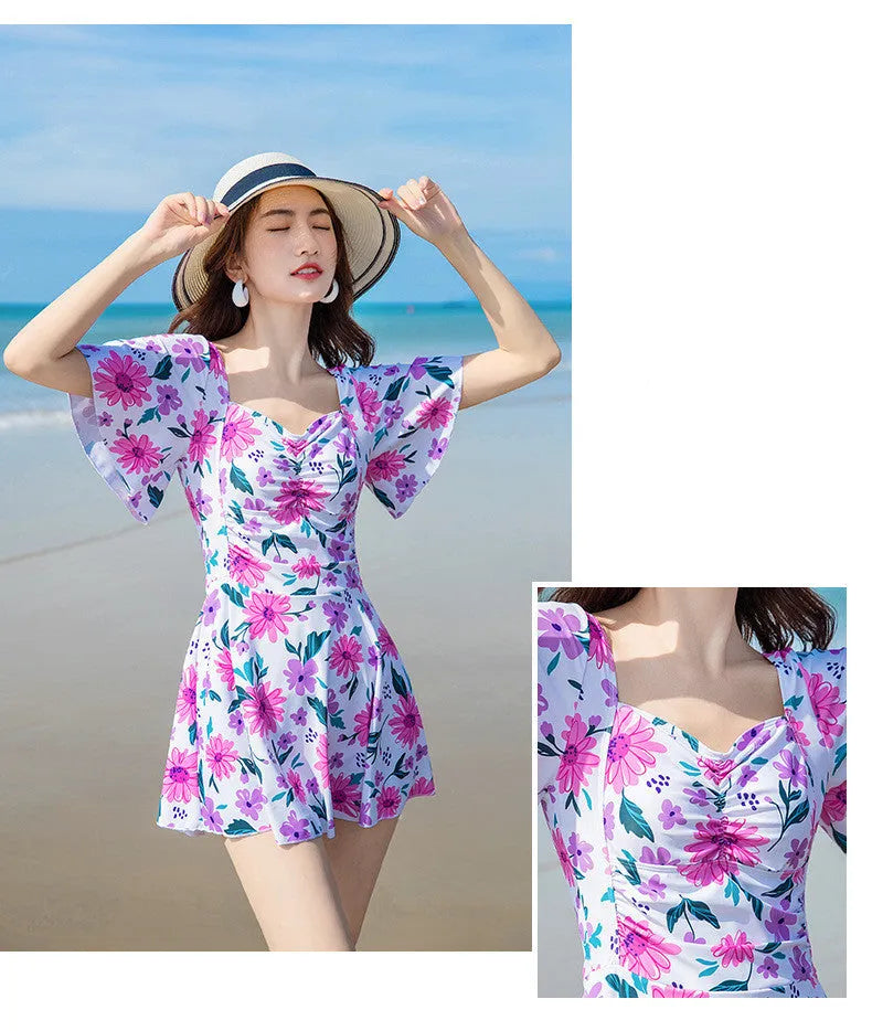Blue floral print women's dress-style one-piece swimsuit on a hanger