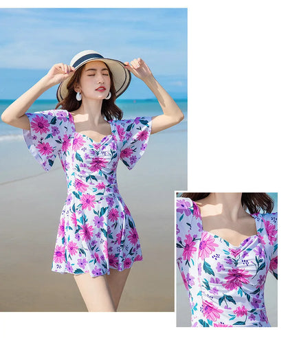 Blue floral print women's dress-style one-piece swimsuit on a hanger