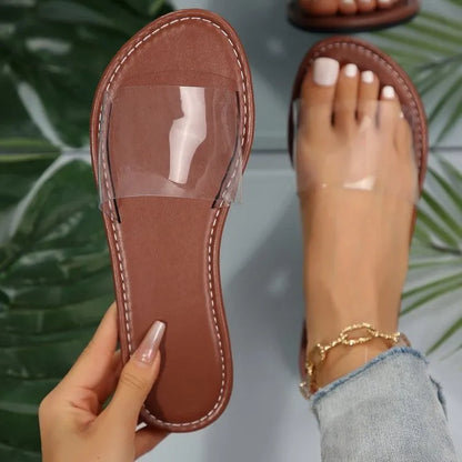 Women's flat transparent slippers in rose red, brown, and white colours made from artificial PU material.