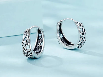 Sterling silver hollow butterfly earrings with zircon accents, retro design measuring 14mm by 5mm