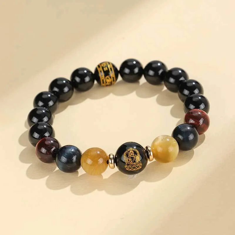 Handcrafted black agate and tiger eye stone beaded bracelet with a central carved zodiac deity charm.