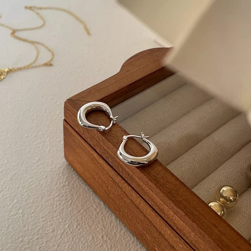 Small fat circle ear clip bracelet in white gold and yellow gold colours