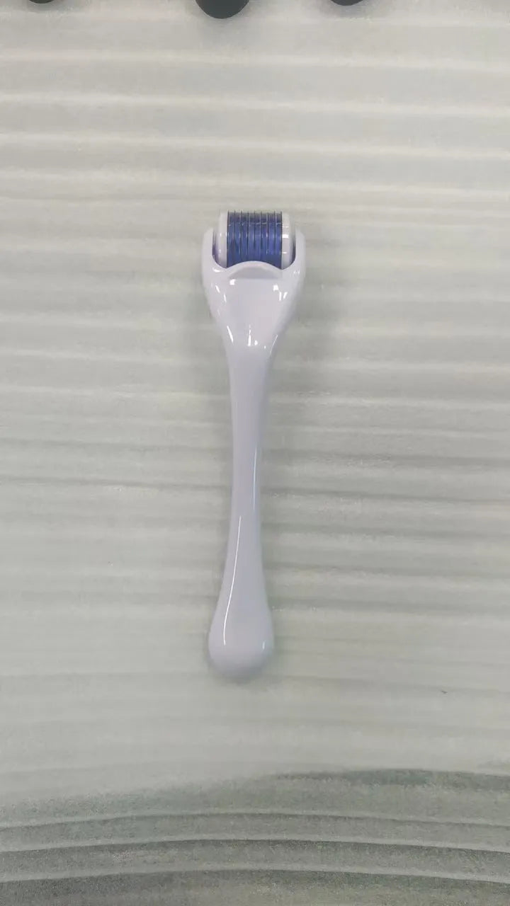 Sterile micro needle derma roller with black handle and coloured wheel on white background