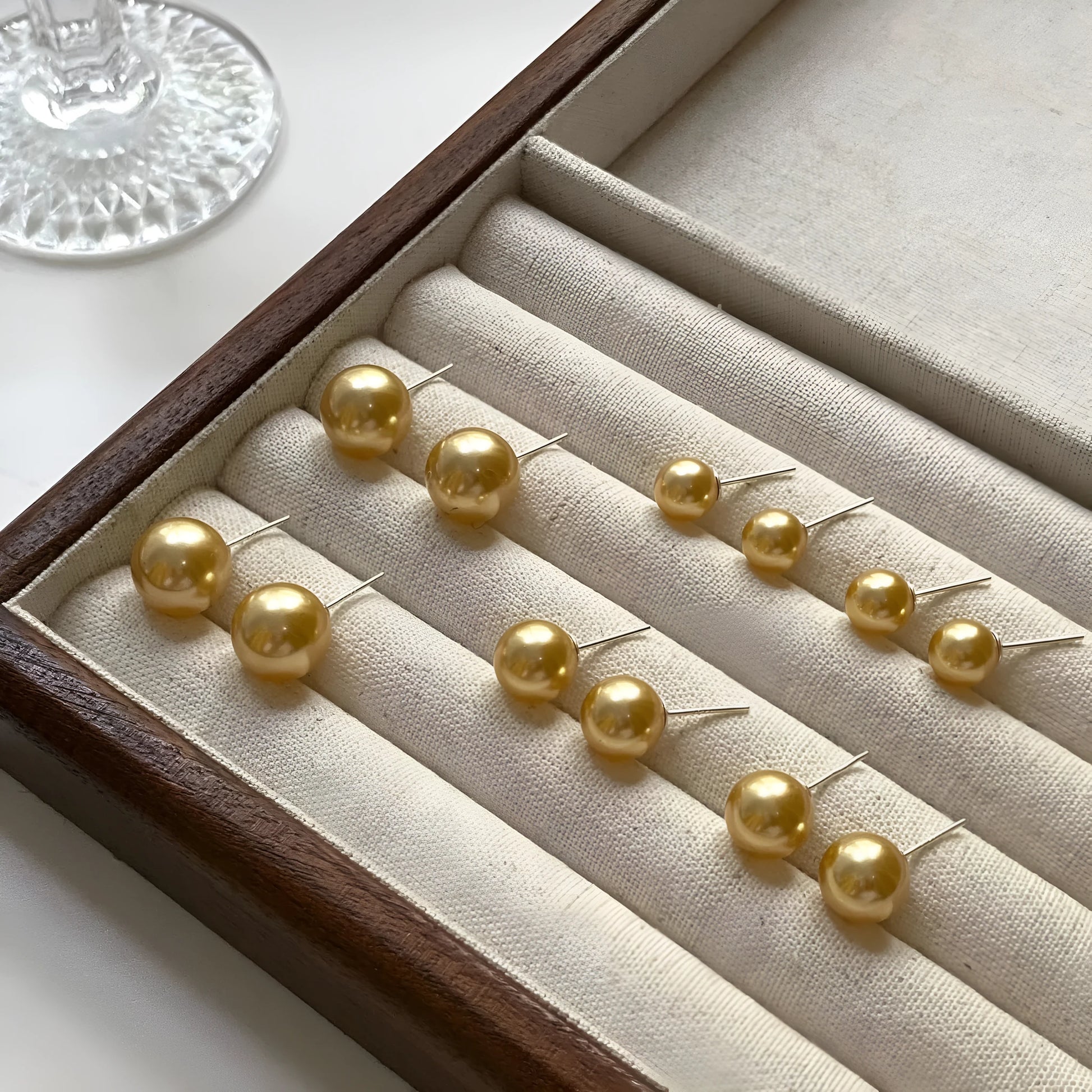 Geometric eight-point star pearl stud earrings in silver with cultured pearls, showing post-and-clasp fastening
