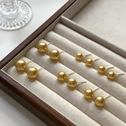 Geometric eight-point star pearl stud earrings in silver with cultured pearls, showing post-and-clasp fastening