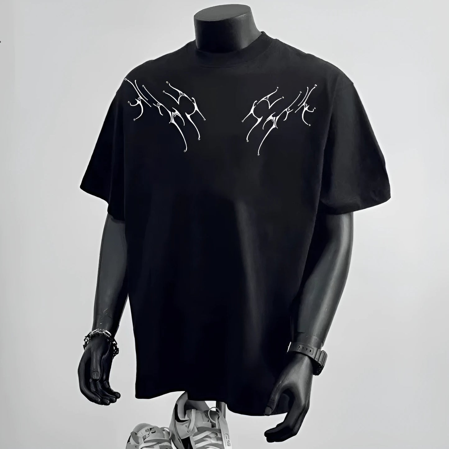 Men's loose fit black cotton short sleeve t-shirt on a hanger.