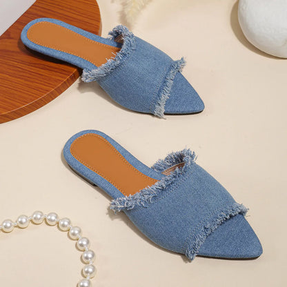 Women's denim flat slippers with tassel detail in apricot colour, showing leather lining.