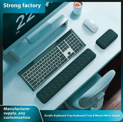 Double-sided black and grey keyboard mouse pad with wrist strap and hand pillow on a desk.