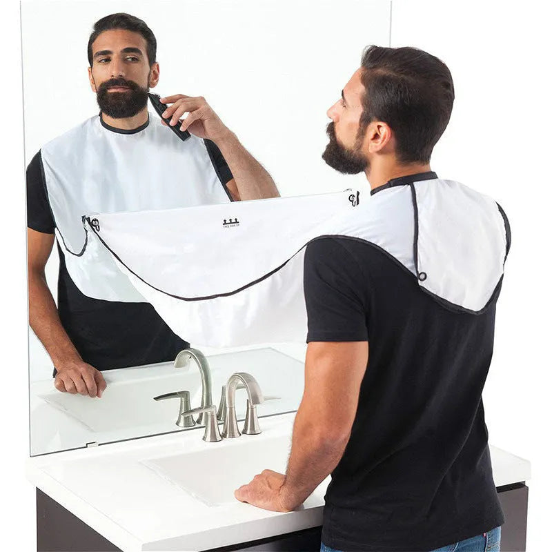 Professional transparent barber shaving cape with built-in tool tray and suction cup, shown in black.