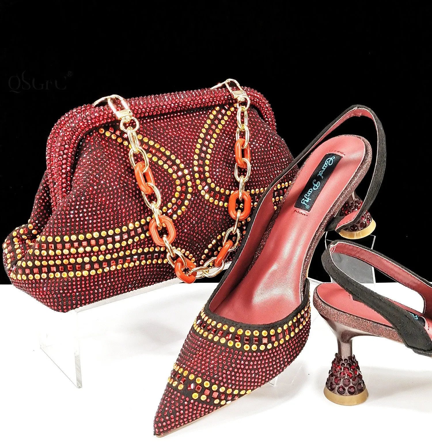 Women's pointed toe high heels with rhinestones and a matching small bag in blue.