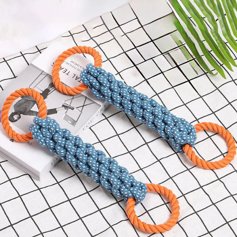 Blue braided bone-shaped cotton rope dog toy with two end rings on a white background.
