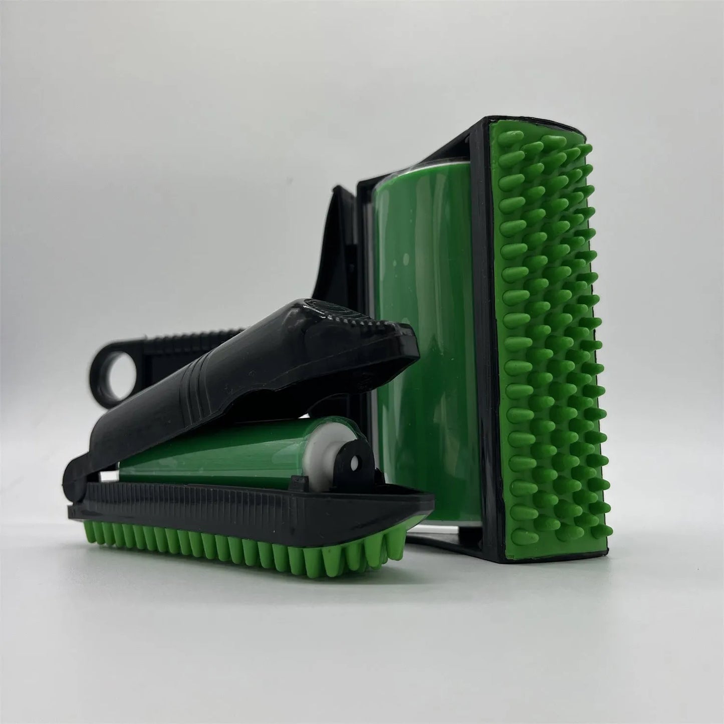 Green and yellow washable adhesive lint rollers for pet hair removal on a fabric background.