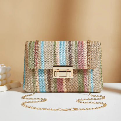Women's small square straw cross-body bag with lock closure, shown in rainbow colour.
