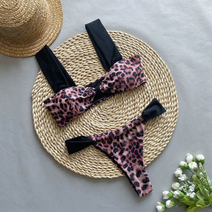 Women's black and leopard print bikini set with tube top and T-pants briefs on a mannequin.